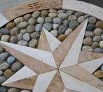 Rose of winds:travertine and pebbles.